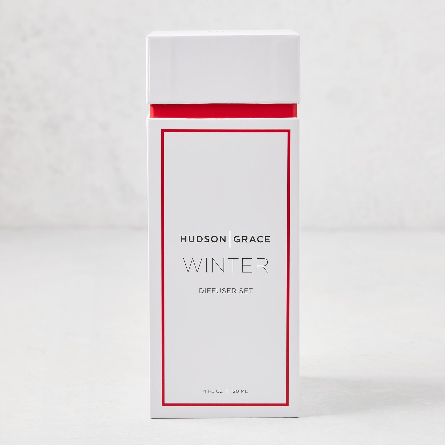 Hudson Grace Winter Scented Reed Diffuser set in a white box with red trim, 4 fl oz.