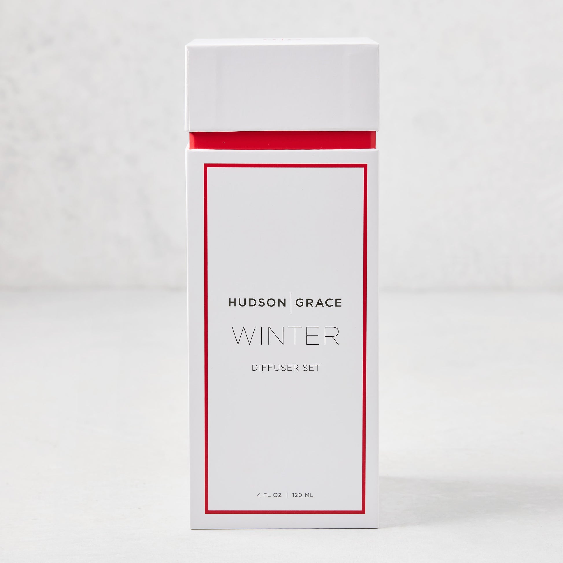 Hudson Grace Winter Scented Reed Diffuser set in a white box with red trim, 4 fl oz.