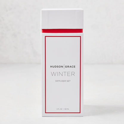 Hudson Grace Winter Scented Reed Diffuser set in a white box with red trim, 4 fl oz.