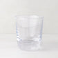 Clear, chunky Hudson Stemless Glass, 3.5"Dia x 4"H, with a thick base, on a white surface.