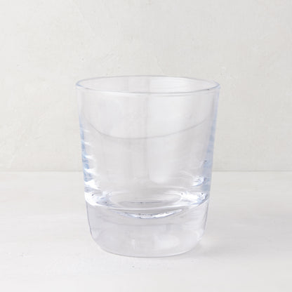 Clear, chunky Hudson Stemless Glass, 3.5"Dia x 4"H, with a thick base, on a white surface.