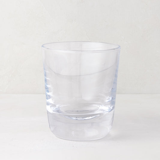 Clear, chunky Hudson Stemless Glass, 3.5"Dia x 4"H, with a thick base, on a white surface.