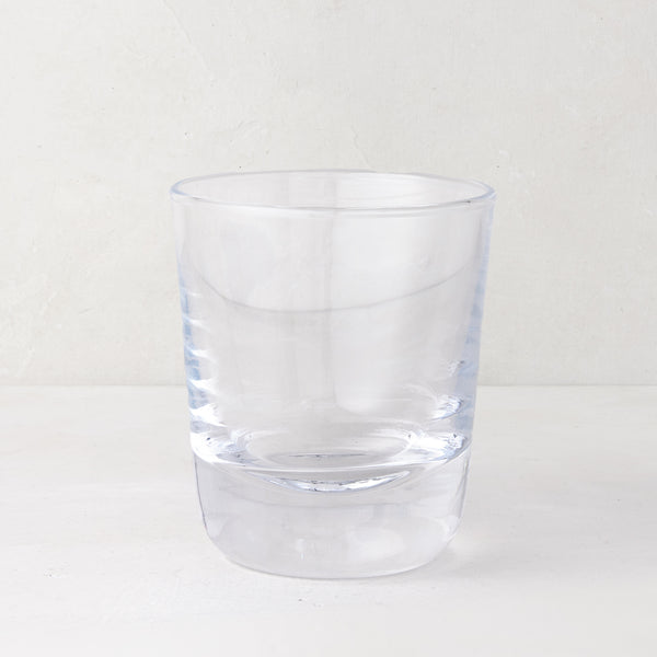 Clear, chunky Hudson Stemless Glass, 3.5"Dia x 4"H, with a thick base, on a white surface.