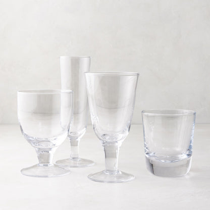 Clear Hudson Water Goblet, Henri Glassware, and other clear glasses on a white surface.