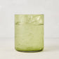 Hugo Aloe Green Double Old Fashioned Glass, filled with ice and a clear drink. Handmade glass, 3.25"Dia x 4"H.