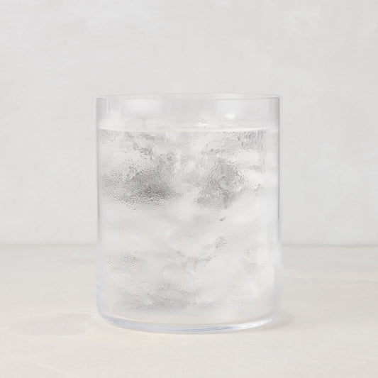Hugo Clear Double Old Fashioned Glass, 3.25"Dia x 4"H, filled with ice and water, condensation on glass.