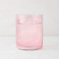 Hugo Pink Double Old Fashioned Glass, 3.25"Dia x 4"H, filled with a pink drink and ice.