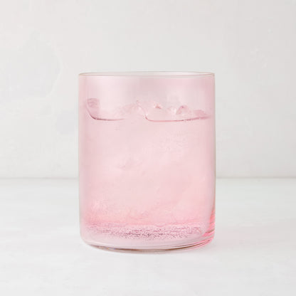 Hugo Pink Double Old Fashioned Glass, 3.25"Dia x 4"H, filled with a pink drink and ice.