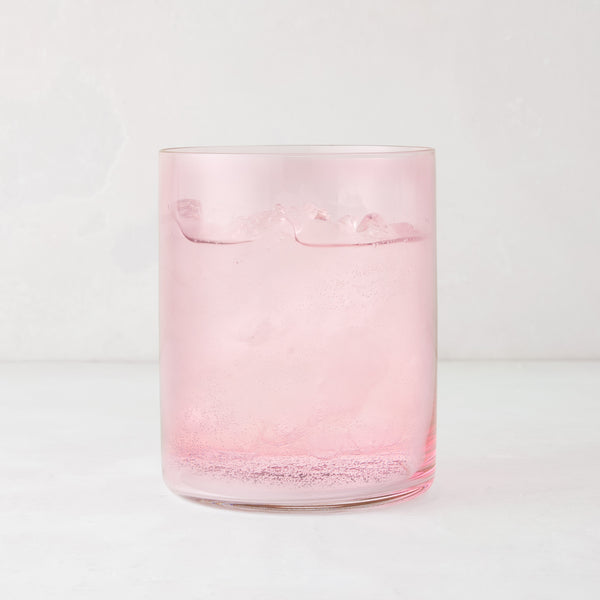 Hugo Pink Double Old Fashioned Glass, 3.25"Dia x 4"H, filled with a pink drink and ice.