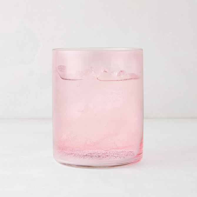 Hugo Pink Double Old Fashioned Glass, 3.25"Dia x 4"H, filled with a pink drink and ice.