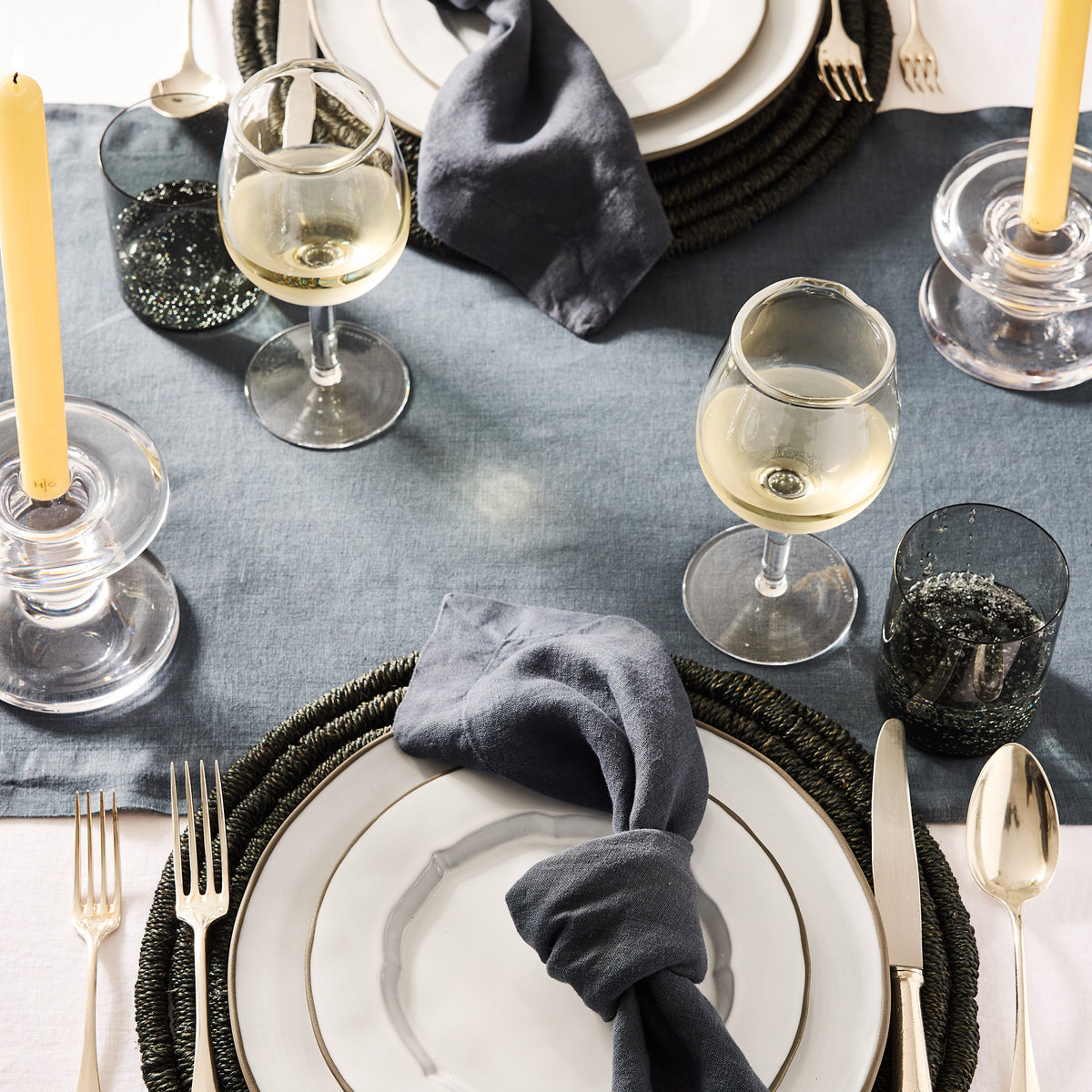 Hugo Smoke Grey Double Old Fashioned Glass on a set table with wine glasses, plates, and candles.