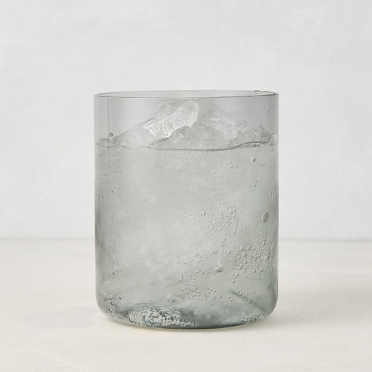 Hugo Smoke Grey Double Old Fashioned Glass with ice and drink, 3.25"Dia x 4"H, handmade in Poland.