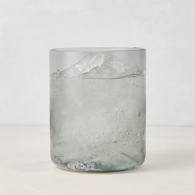 Hugo Smoke Grey Double Old Fashioned Glass with ice and drink, 3.25"Dia x 4"H, handmade in Poland.