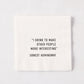 White 5.5-inch square 3-ply paper cocktail napkin with black text reading I Drink To Make Other People Interesting.