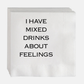 White paper cocktail napkins with "I HAVE MIXED DRINKS ABOUT FEELINGS" in black text.