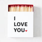 White matchbox with I Love You text and red heart, filled with long wooden matches featuring red tips.