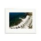 Il Pellicano Paradise framed wall art print of an Italian hotel's seaside terrace with lounge chairs and clear blue water.