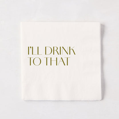 White 5.5" square paper cocktail napkin with "I'LL DRINK TO THAT" in gold text.