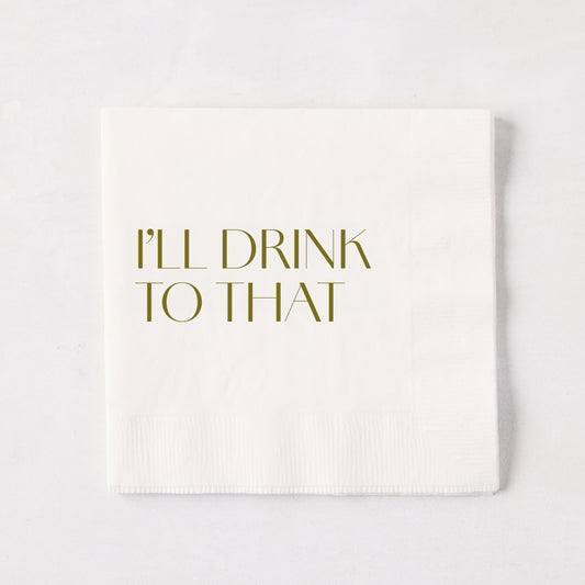 White 5.5" square paper cocktail napkin with "I'LL DRINK TO THAT" in gold text.