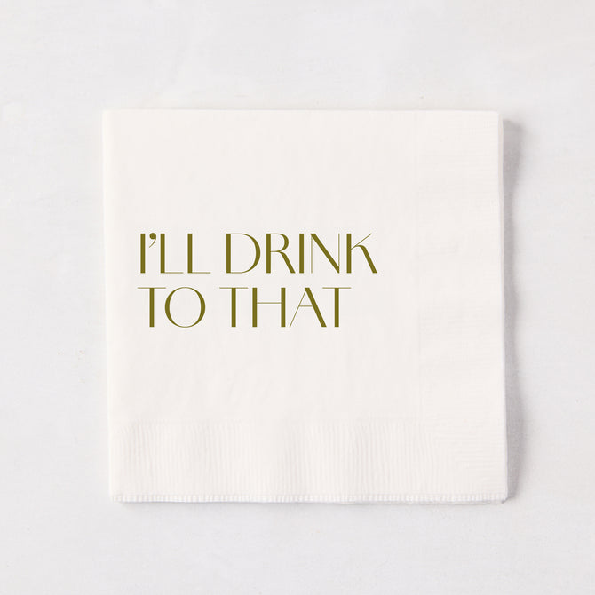 White 5.5" square paper cocktail napkin with "I'LL DRINK TO THAT" in gold text.