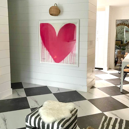 Kerri Rosenthal's "In My Heart" art print, a large pink drippy heart in a white frame on a shiplap wall.