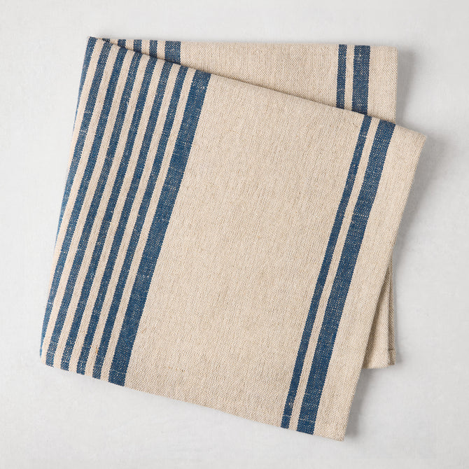 Folded indigo blue boat stripe natural napkin, 50% cotton, 50% linen.