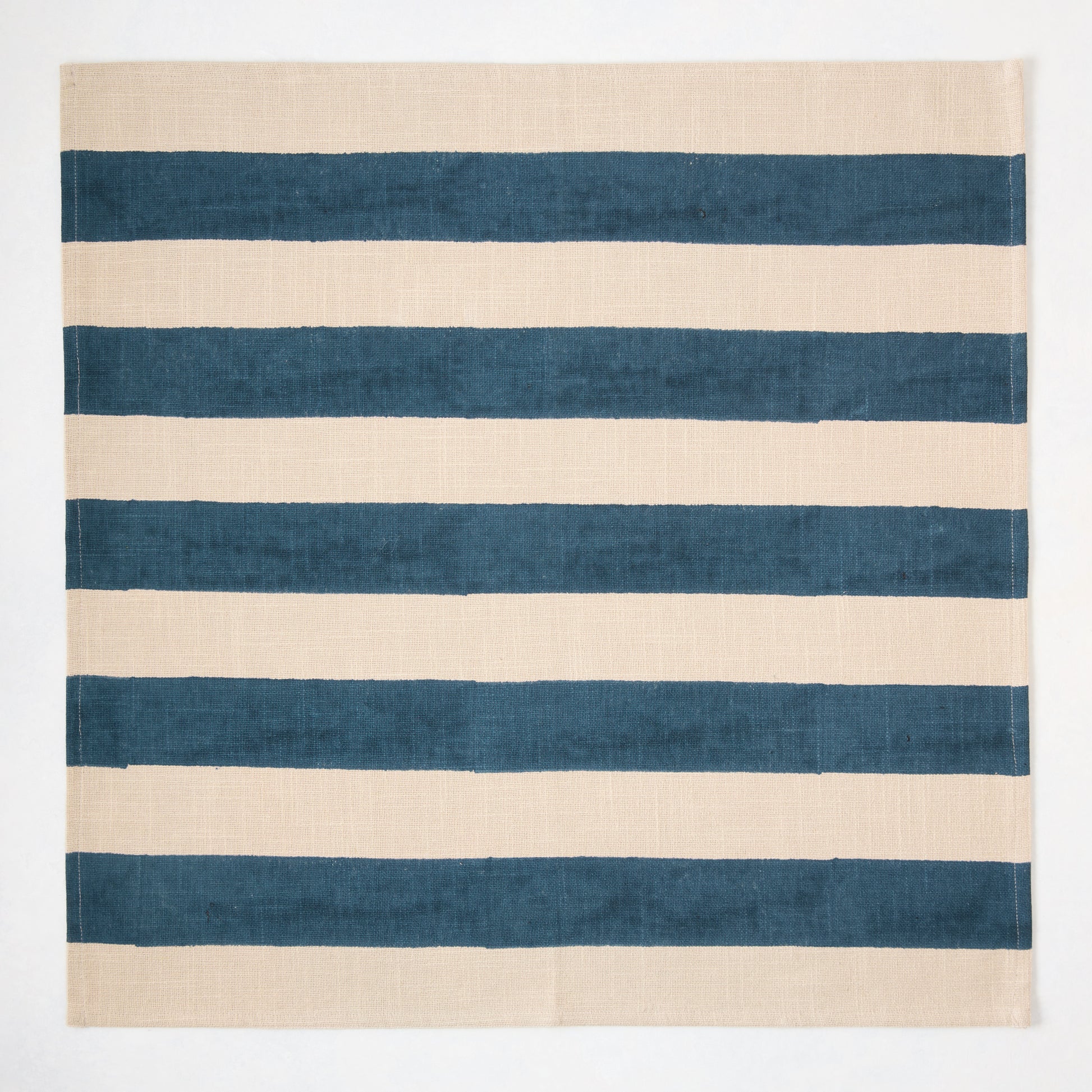 Indigo Blue Hampton Stripe Natural Cotton Napkin, 22" square, with wide blue stripes on a khaki base.