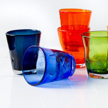 Indigo Henri Glass, 8 oz., with orange and green mouth-blown glassware, showing unique air bubbles.