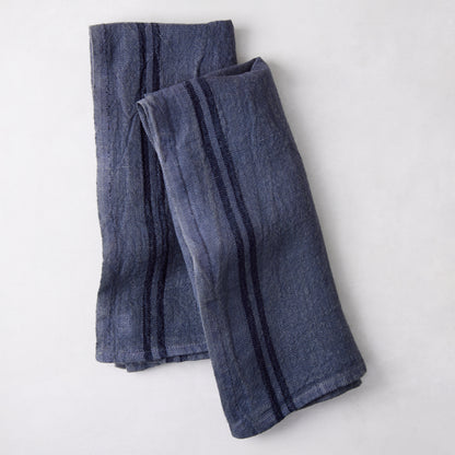 Set of 2 indigo blue striped French linen hand towels, folded on a white surface.