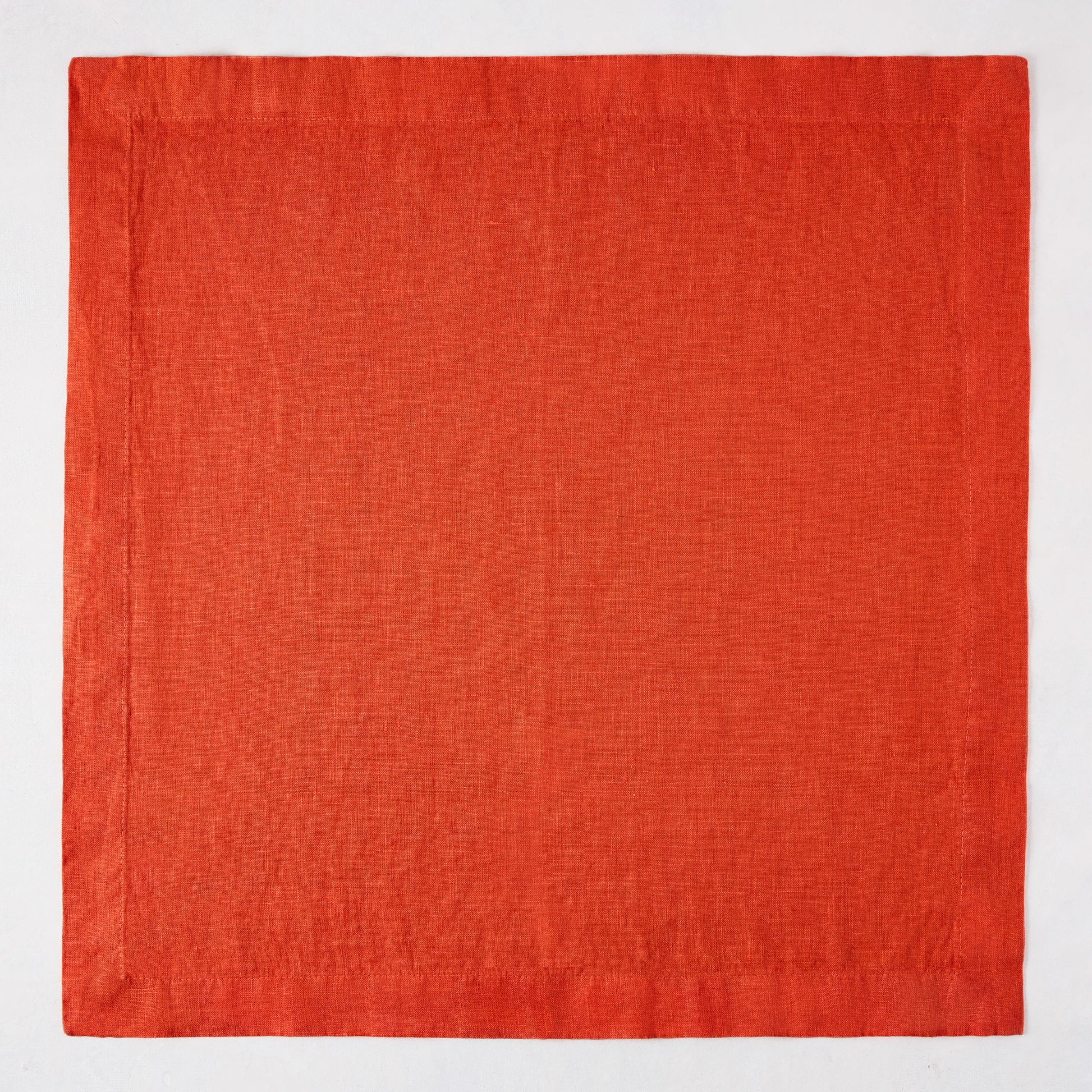 International Orange HG Signature hand-dyed linen napkin, 22-inch square, with mitered corners.