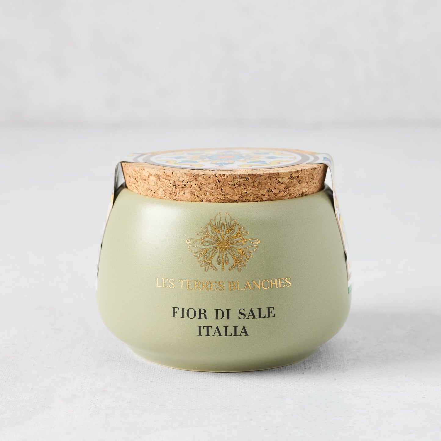 Italia Fleur De Sel salt in a green artisanal ceramic pot with a natural cork lid and gold text.