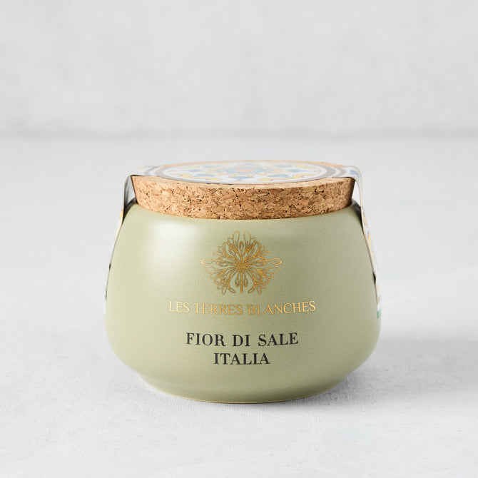 Italia Fleur De Sel salt in a green artisanal ceramic pot with a natural cork lid and gold text.
