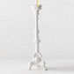 20.5-inch tall white ceramic footed candlestick with ornate antique-style detailing and a taper candle.
