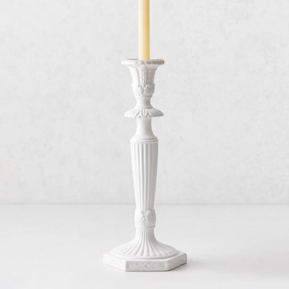 Small white Italian ceramic candlestick with intricate antique-style detailing and a taper candle.