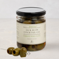 Jack Rudy Cocktail Co. Vermouth Brined Olives, 16 fl. oz. glass jar with black lid and three olives on a skewer.
