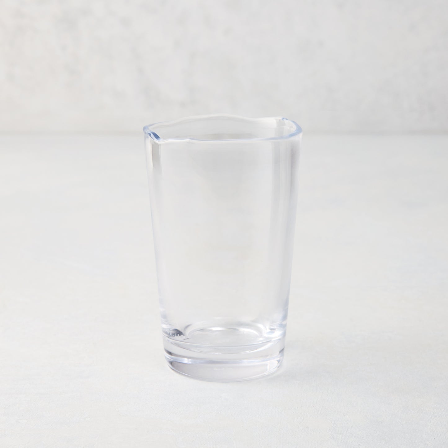 Clear Jacob Scissor-Cut Glass Tumbler, 8 oz., with a unique rippled rim.