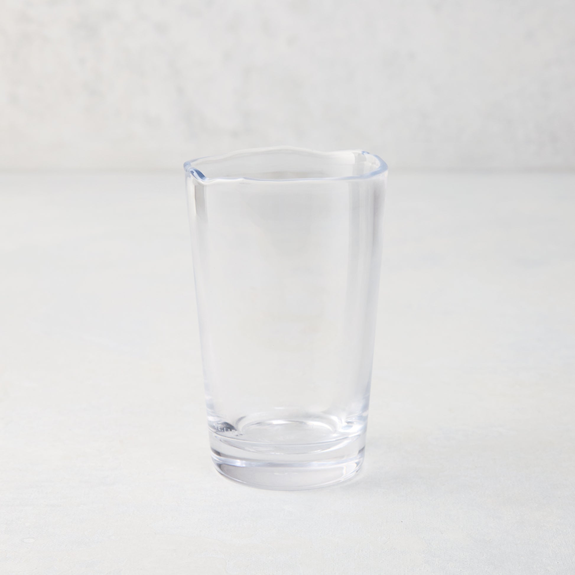 Clear Jacob Scissor-Cut Glass Tumbler, 8 oz., with a unique rippled rim.