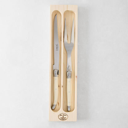 Jean Dubost Laguiole carving set: stainless steel knife and fork with ivory handles in a wooden box.