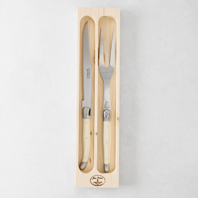 Jean Dubost Laguiole carving set: stainless steel knife and fork with ivory handles in a wooden box.