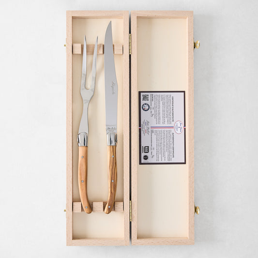 Jean Dubost Laguiole carving set with olive wood handles and stainless steel knife and fork in a wooden box.