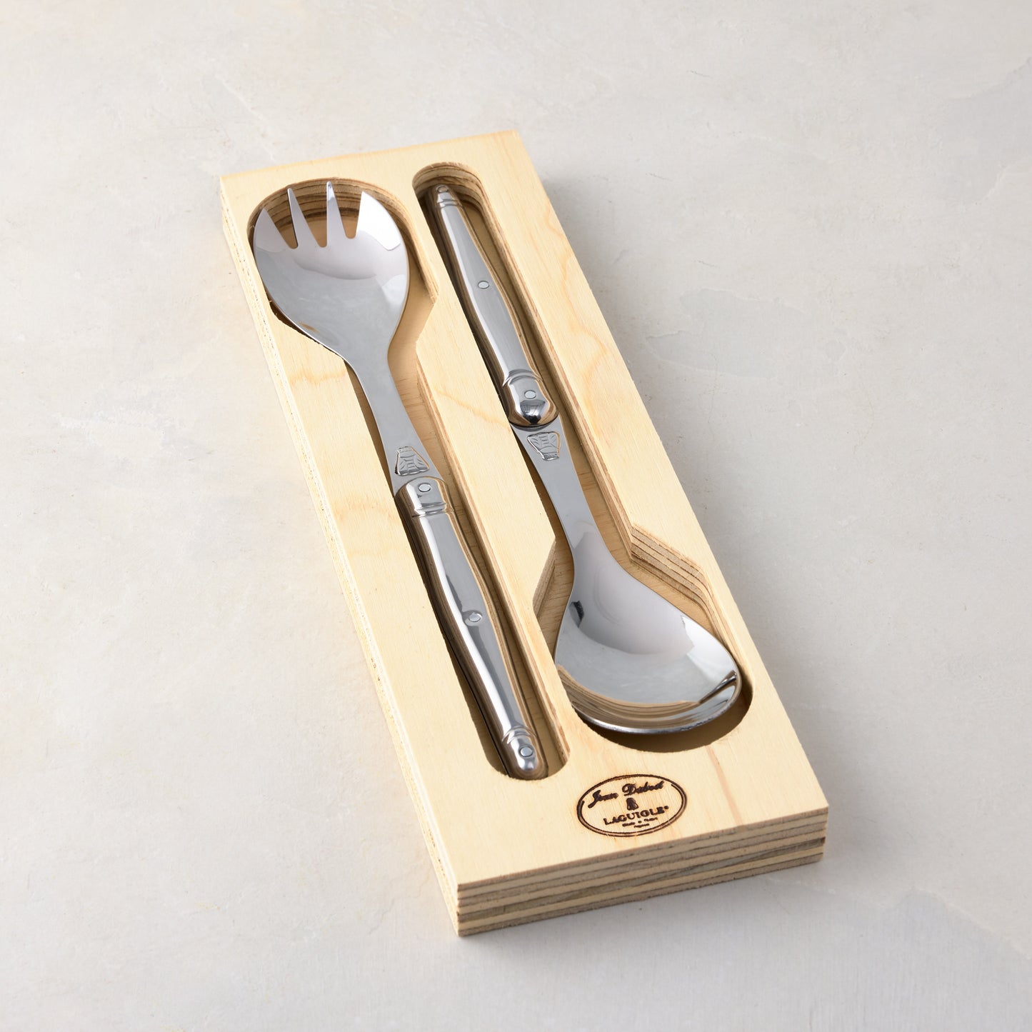 Jean Dubost Laguiole stainless steel salad server set in a light beech wood storage box.