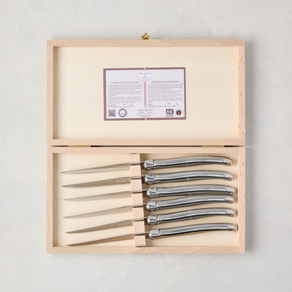 Jean Dubost Laguiole stainless steel table knives, set of 6, in an open light wood storage box with authenticity certificate.