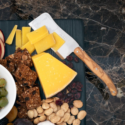Jean Dubost Olive Wood 3-piece cheese knife set with stainless steel blades, shown on a cheese board with cheese and crackers.