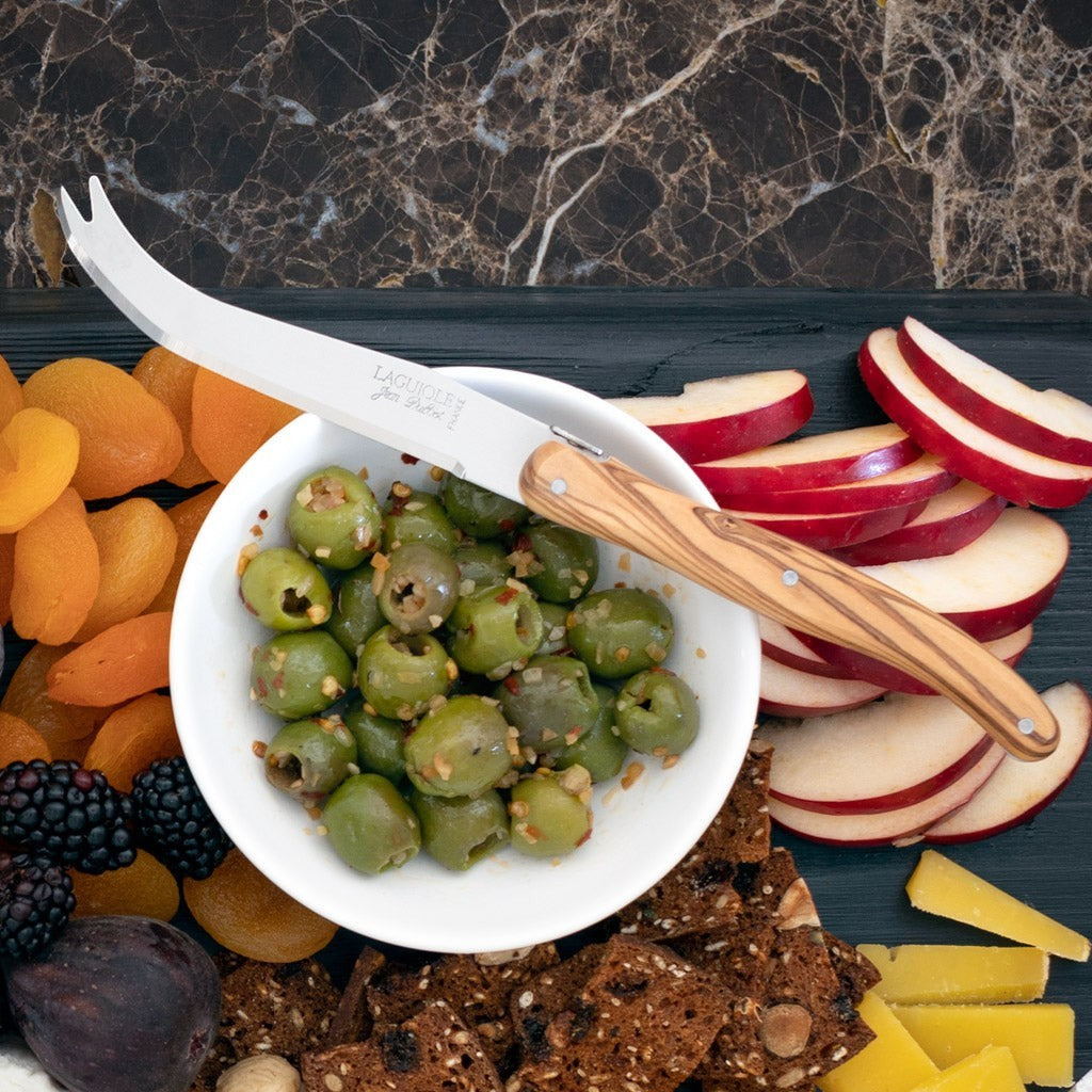 Jean Dubost Olive Wood 3-piece cheese knife set with stainless steel blades, olivewood handle, on a cheese board.