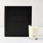 Black leather "Joy of Cooking" cookbook with blind embossed title, next to a Hudson Grace Kitchen candle.