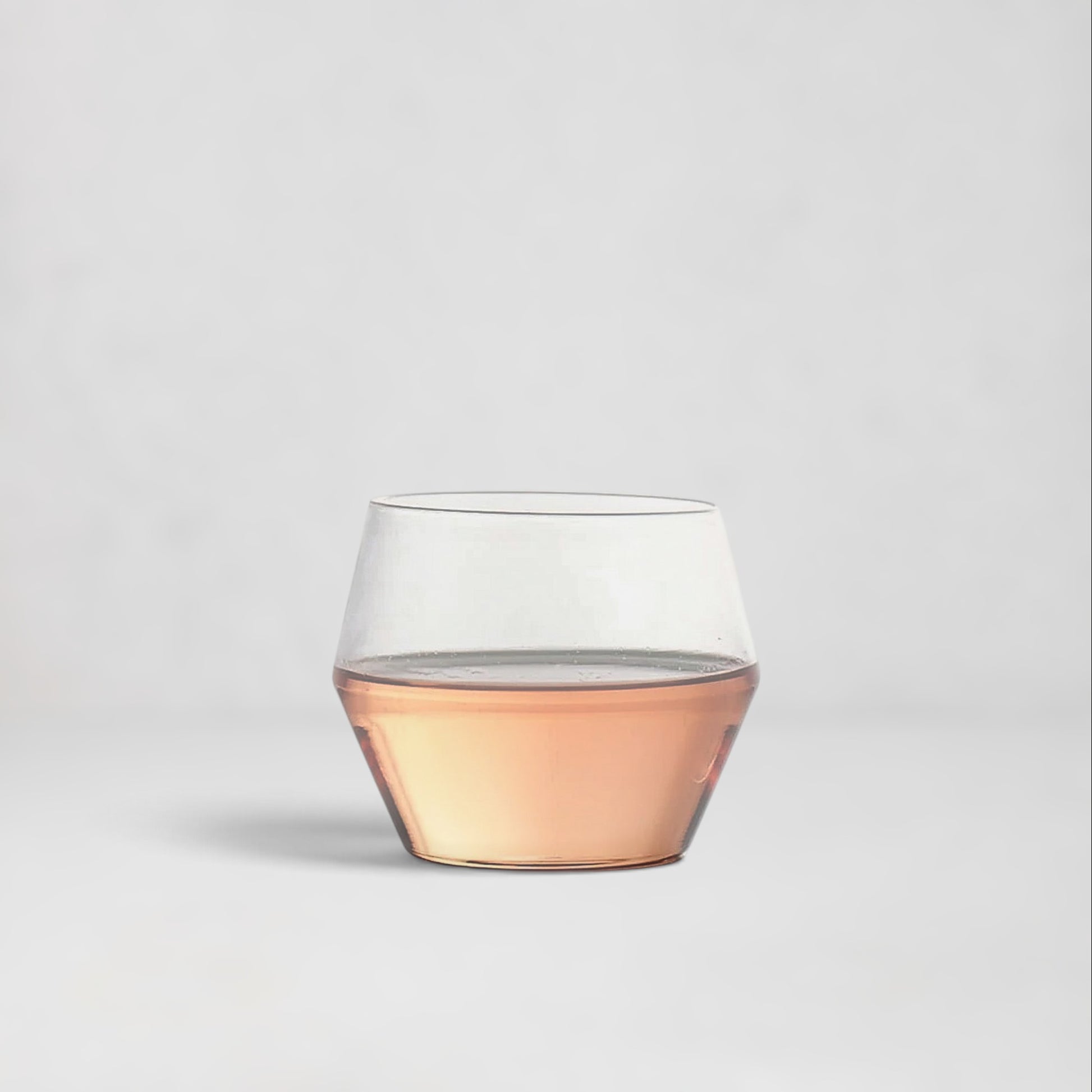 Hudson Grace Juniper double old fashioned glass with a sculptural geometric silhouette and rose-tinted base.