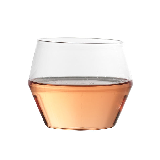 Juniper double old fashioned glass with a geometric silhouette filled with rose-colored liquid, 10oz capacity.