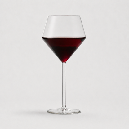 Juniper red wine glass with a modern geometric bowl and thin stem, filled with red wine, 17oz capacity.