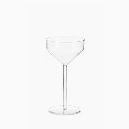 Clear glass Juniper cocktail coupe with a modern, geometric silhouette and a tall, slender stem on a white background.
