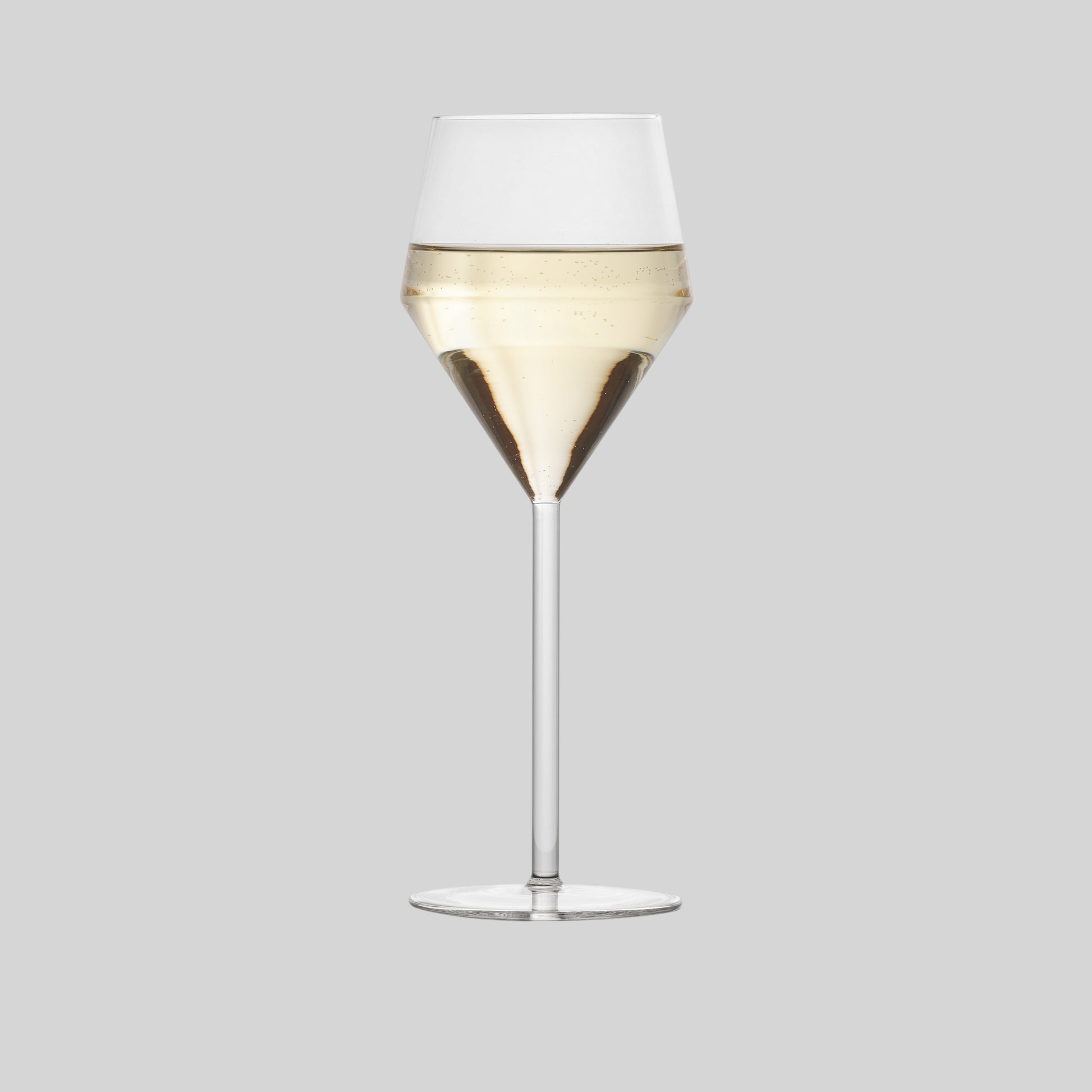 Hudson Grace Juniper white wine glass with a modern geometric silhouette and long thin stem, isolated on white.